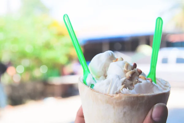 Hand holding ice-cream in coconut fruit, Summer lifestyle — Stock Photo, Image