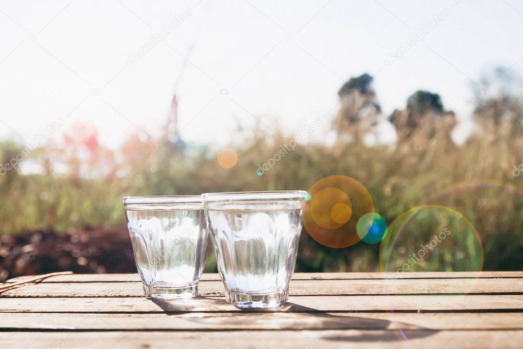 Two glasses of pure water with nature in background, Healthy lifestyle, Camping 