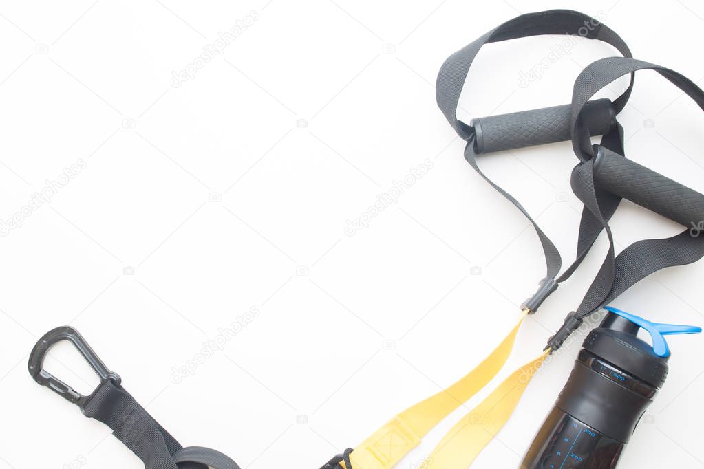 TRX training strap and bottle water on white background with copy space