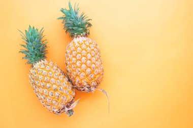 Turuncu renk arka plan üzerinde düz yatıyordu tüm ananas