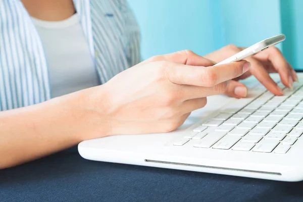 Young smart woman using mobile device and laptop computer, Technology, Workplace, Online shopping