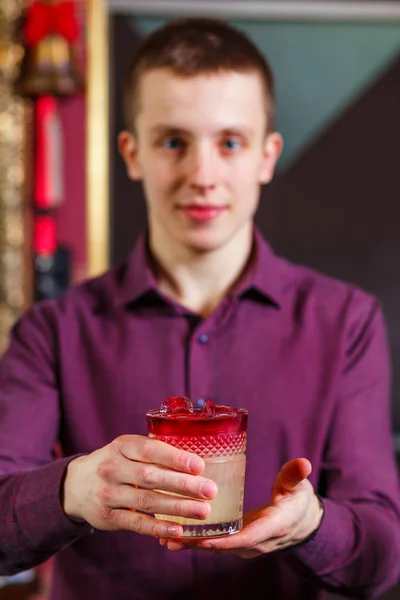 Cheerful bartender gives the cocktail to customer. — Stock Photo, Image