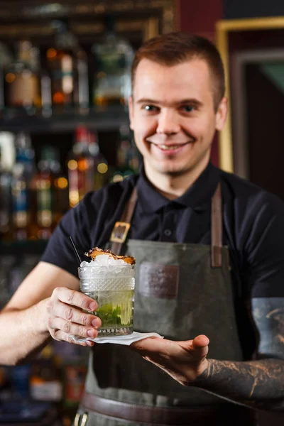 Glada bartendern ger cocktail till kund. — Stockfoto