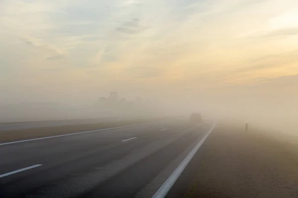 Freeway and a car in fog — Stock Photo, Image