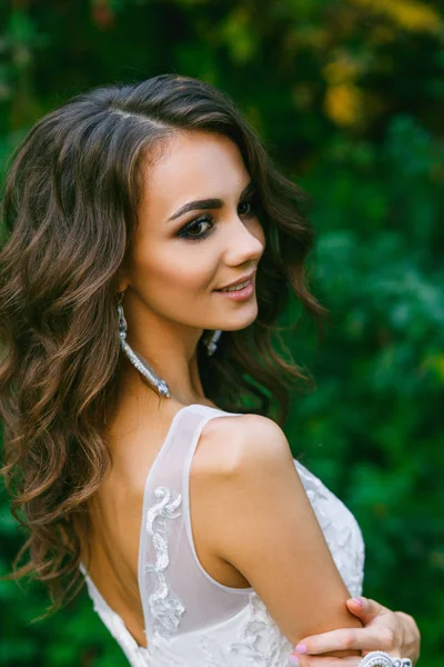 Beautiful young bride with long curly hair — Stock Photo, Image