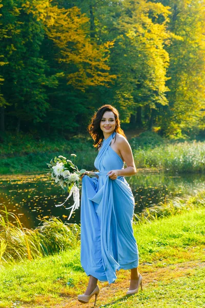 Beautiful young bridesmaid with curly hair — Stock Photo, Image