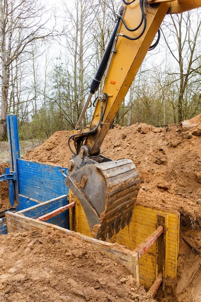 Installation of metal supports to protect the walls of the trench.