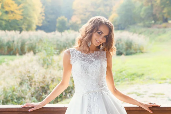 Beautiful young bride with long curly hair — Stock Photo, Image