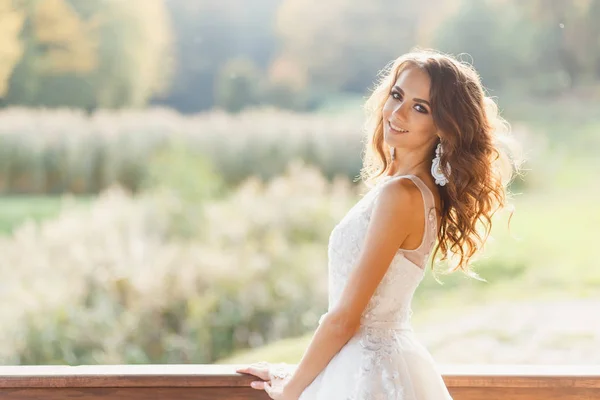 Beautiful young bride with long curly hair — Stock Photo, Image