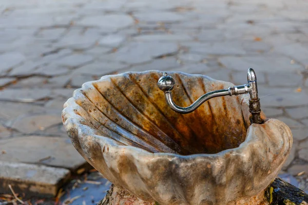 Ancient drinking fountain in shape of sink — Stock Photo, Image