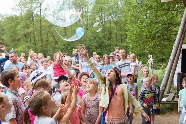 Group of kids have fun with big soap bubbles — Stock Photo, Image