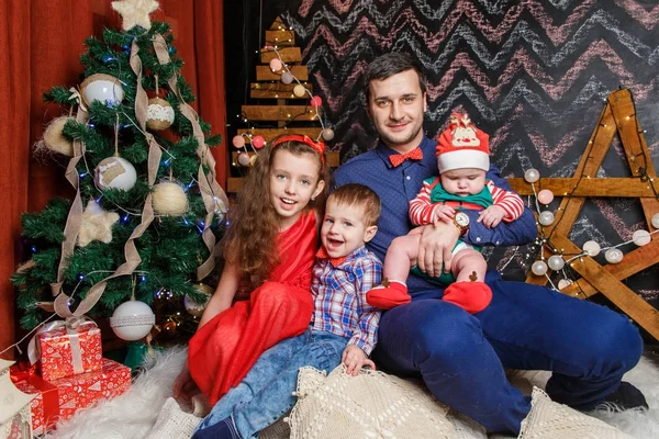 Pai com crianças em uma sessão de fotos de Natal — Fotografia de Stock