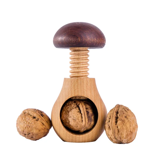 Whole walnuts and wooden screw nutcracker isolated on white background — Stock Photo, Image