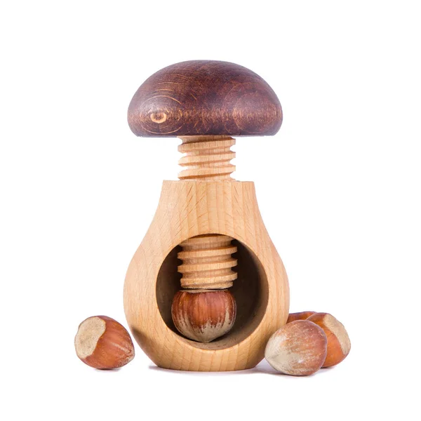 Wooden mushroom shape nutcracker and hazelnuts — Stock Photo, Image