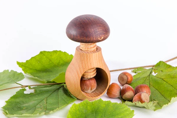 Wooden mushroom shape nutcracker and hazelnuts — Stock Photo, Image