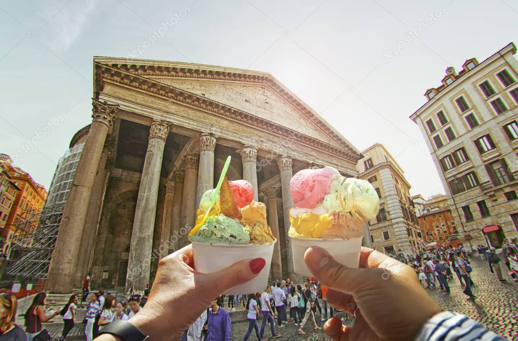 Couple with beautiful bright  sweet Italian ice-cream with different flavors  in the hands   on background of Pantheon , Italy 