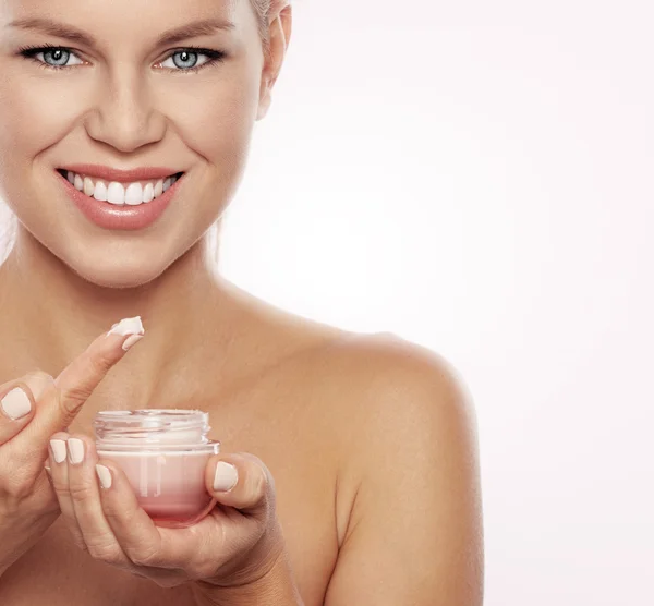 Woman with facial cream — Stock Photo, Image