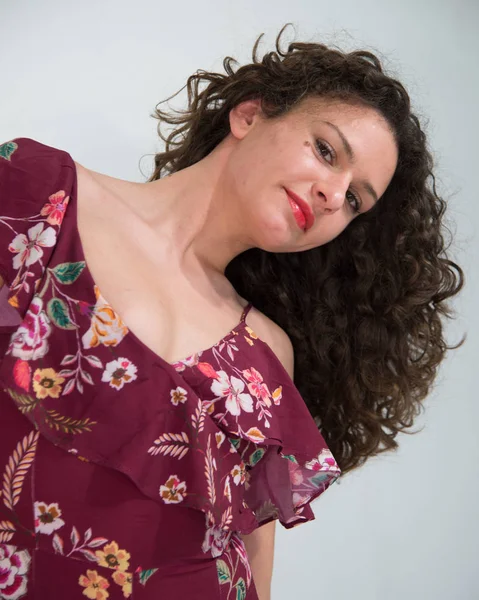 portrait of a wavy, curly haired girl with flowered strapless dress, Fashion Woman