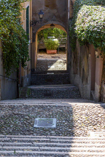 Characteristic cobbled pedestrian street to go up to the castle of Brescia, Italy.