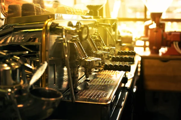 Espresso coffee machine on a counter in a cafe with sun flare back light
