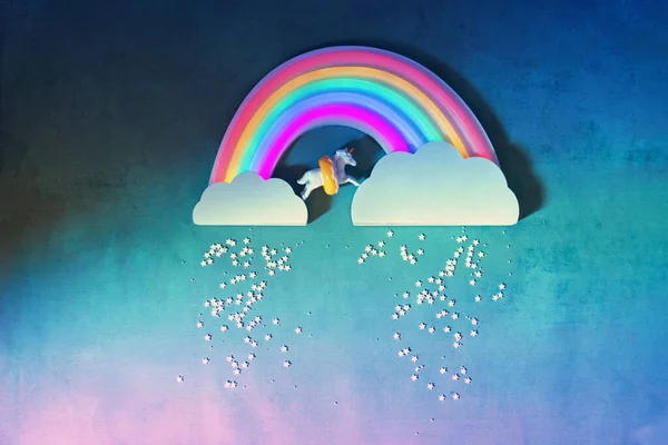 Единорог с сияющей неоновой радугой в небе — стоковое фото
