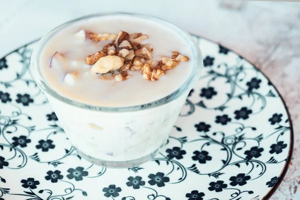 Albanian yogurt dessert with honey and walnuts nuts over white plate — Stockfoto