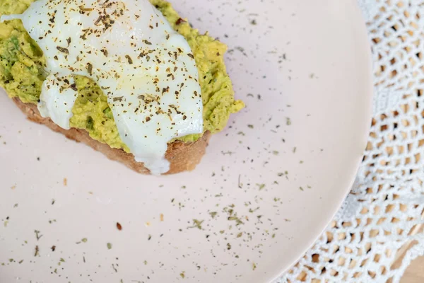 Whole wheat toasted bread with avocado and poached egg