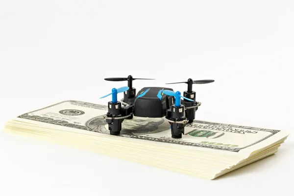 Mini drone is on a pack of dollars - ready for take-off