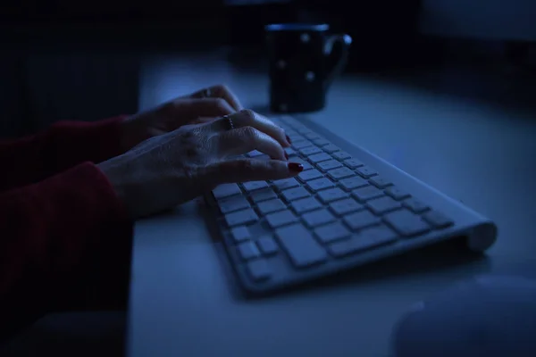 woman typing computer night light