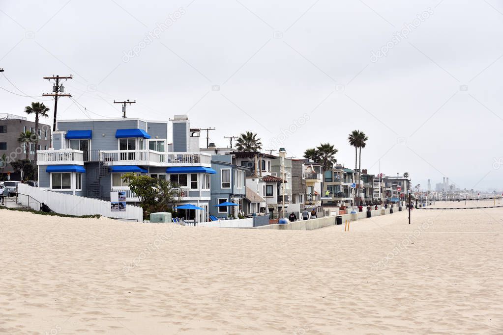 Luxury homes and vollyball courts line the beach at Manhattan Beach