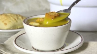 Bir kaşık dolusu tatlı patates çorbası içiyorum.