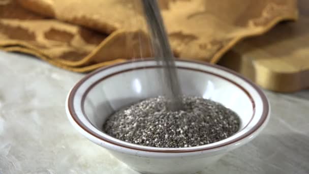 Pouring Black Chia Seeds Bowl Slow Motion — Stock Video