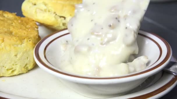 Spooning Country Gravy Bowl Fresh Baked Biscuits Slow Motion — Stock Video