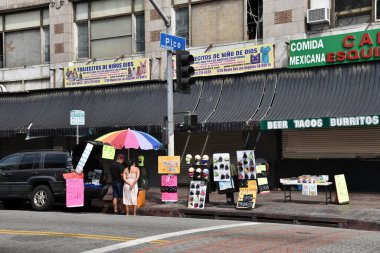 Los Angeles, CA / USA - 28 Nisan 2020: Coronavirüs salgını sırasında yüz maskesi satan bir sokak satıcısı