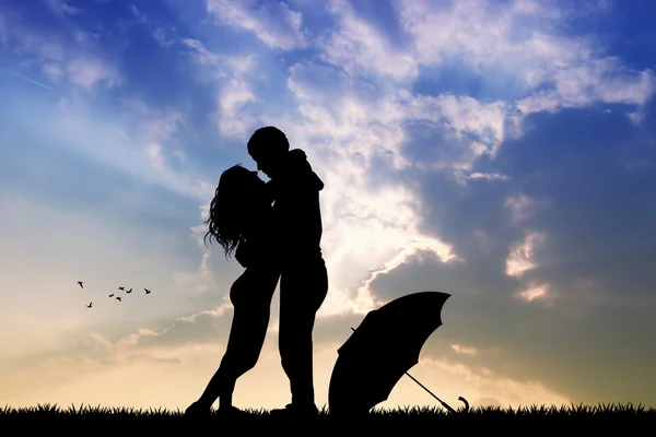 Couple in the rain at sunset — Stock Photo, Image