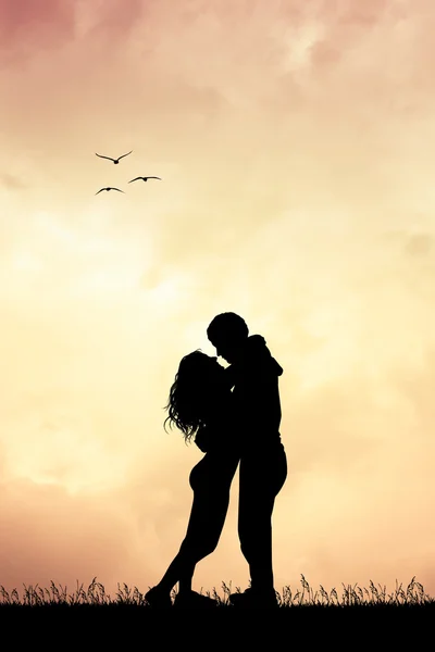Couple kissing at sunset — Stock Photo, Image