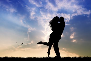 Gün batımında öpüşen çift