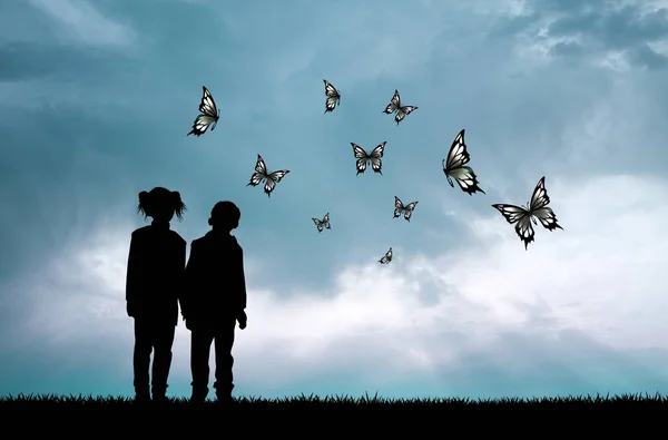 Children and butterflies at sunset — Stock Photo, Image