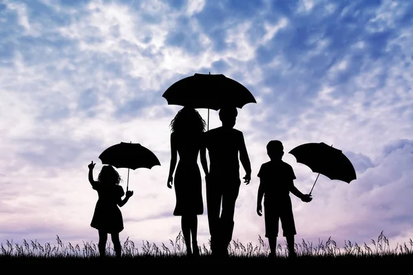 Family in the rain at sunset — Stock Photo, Image