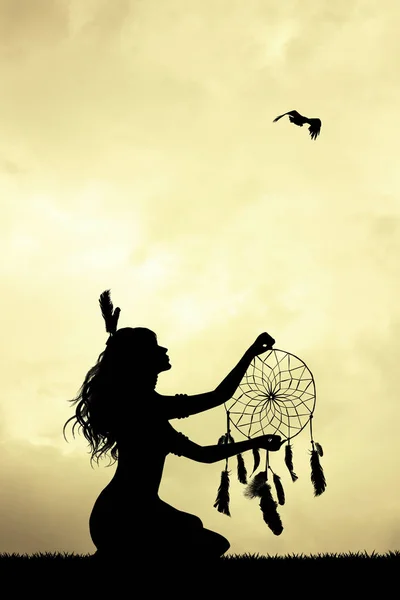Girl with dreamcatcher at sunset — Stock Photo, Image