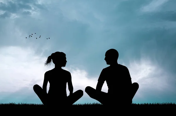 Couple doing yoga at sunset — Stock Photo, Image