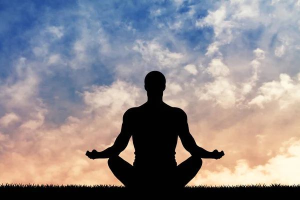 Man doing yoga at sunset — Stock Photo, Image