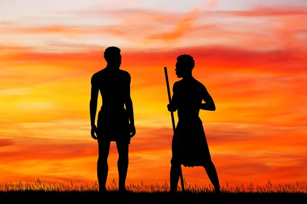 Afrikaanse mannen silhouet bij zonsondergang — Stockfoto