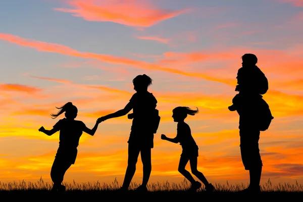 Joyful family silhouette at sunset — Stock Photo, Image