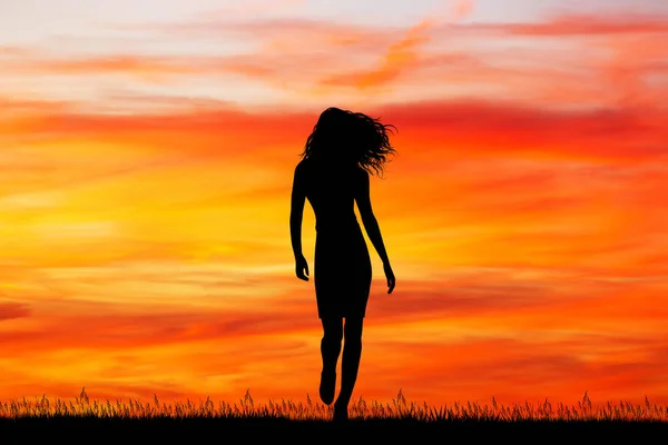 Beautiful girl walking at sunset — Stock Photo, Image