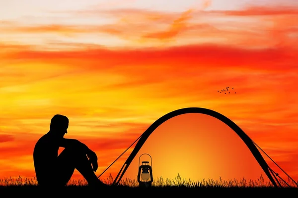 man camping at sunset
