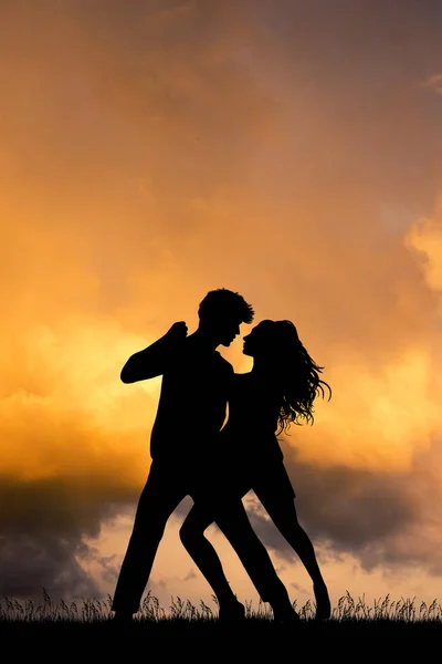 illustration of man and woman  dancing at sunset