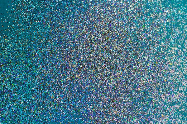 Kolorowe iskry holograficzne na niebieskim tle. — Zdjęcie stockowe