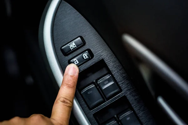 Finger push lock button of car doors.