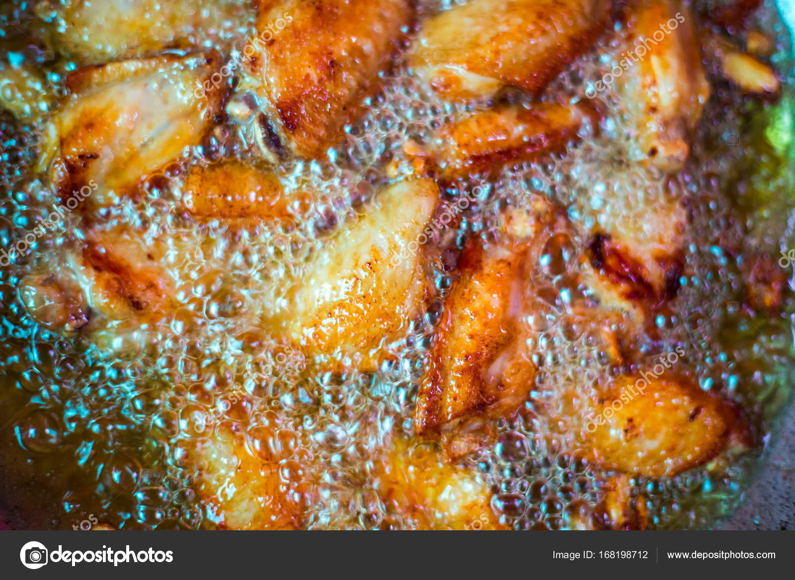 Close up fried chicken wings in boiling oil. ⬇ Stock Photo, Image by
